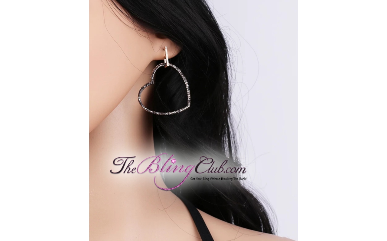 the bling club gold black crystal heart earrings on model